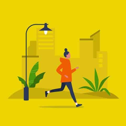 person with hair in a bun and wearing an orange hoodie, running through city, under street lamp