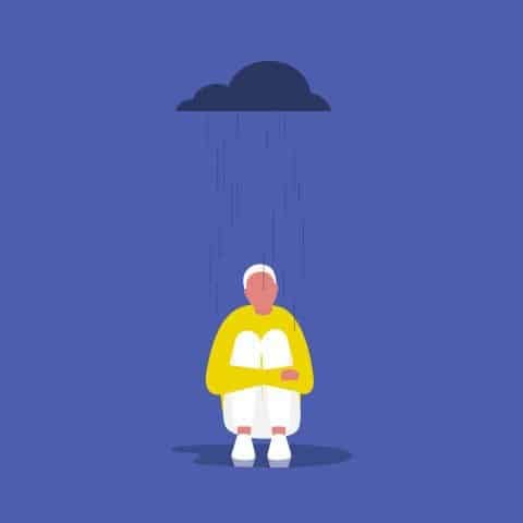 person with short white hair, wearing yellow sweatshirt, sat holding knees under a raincloud, with a blue background